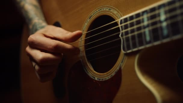 Una persona irreconocible ensayando en un estudio de música. Hombre mano tocando la guitarra. - Metraje, vídeo
