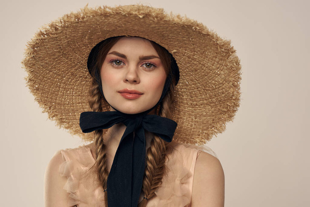 portrait of a romantic girl in a dress and a straw hat with a black ribbon emotions cropped view - Фото, изображение