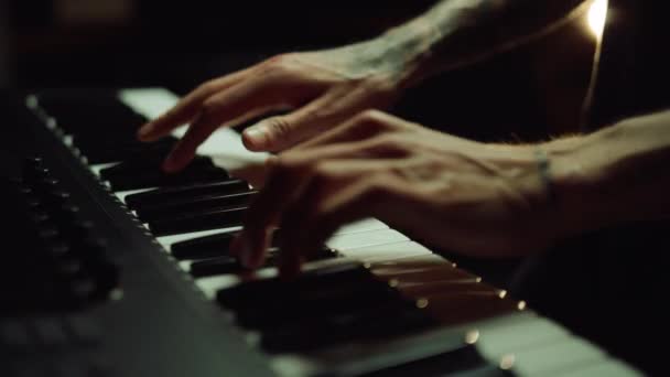 Man hands pressing keys on piano in recording studio. Musician making song. - Footage, Video