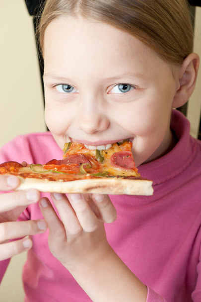 Cheerful little girl with pizza - 写真・画像
