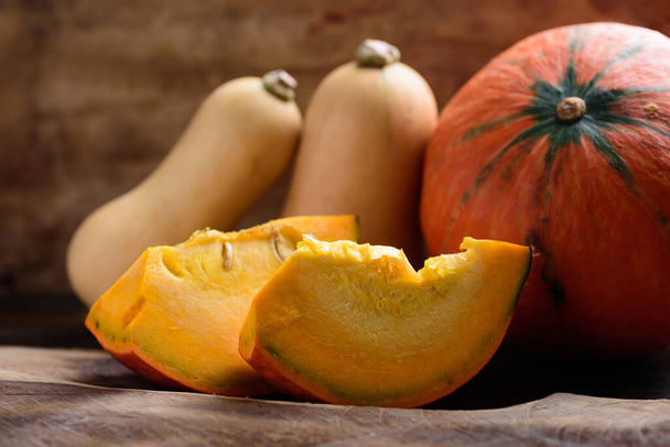 Autumn Orange Pumpkin and butternut squash on wooden background - Fotó, kép