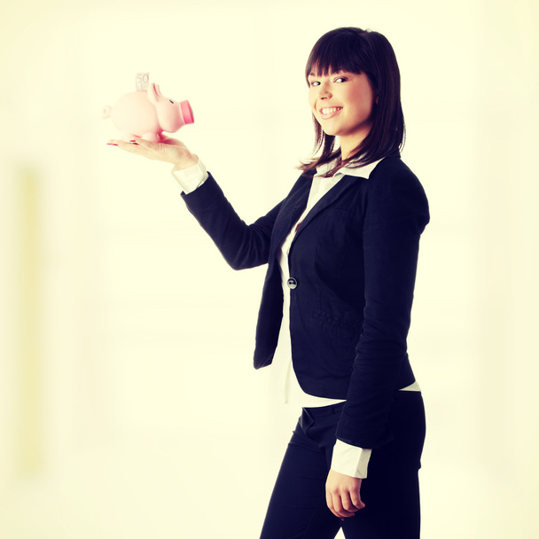 Woman Holding Piggy Bank - Фото, изображение
