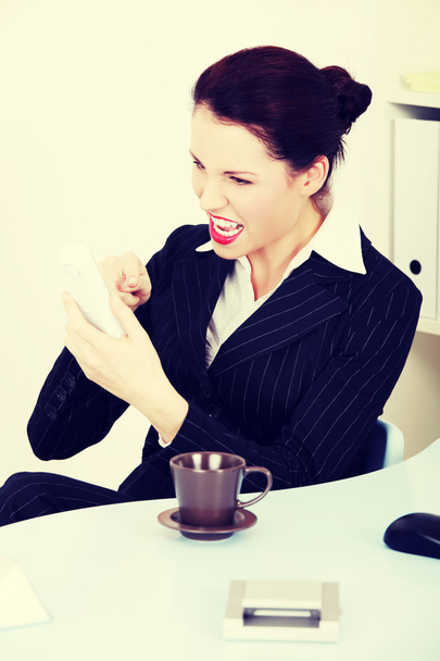 Business woman shouting through the phone. - Фото, изображение