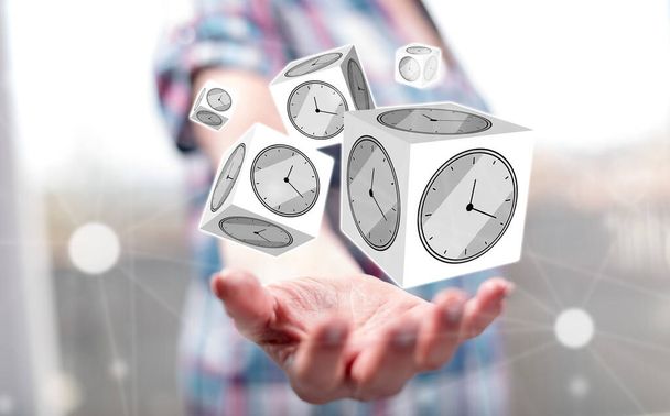 Time management concept above the hand of a woman in background - Photo, Image