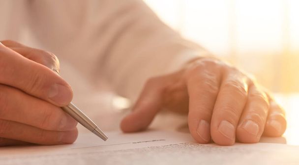 Businessman is signing a contract, close up of male hand putting signature - Fotoğraf, Görsel