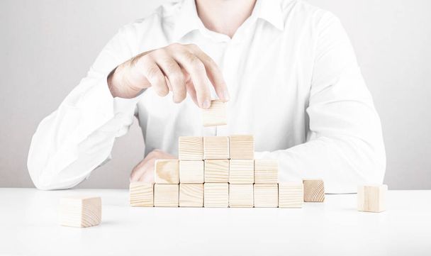 businessman climbs the career ladder. Business concept from cubes. - Foto, imagen