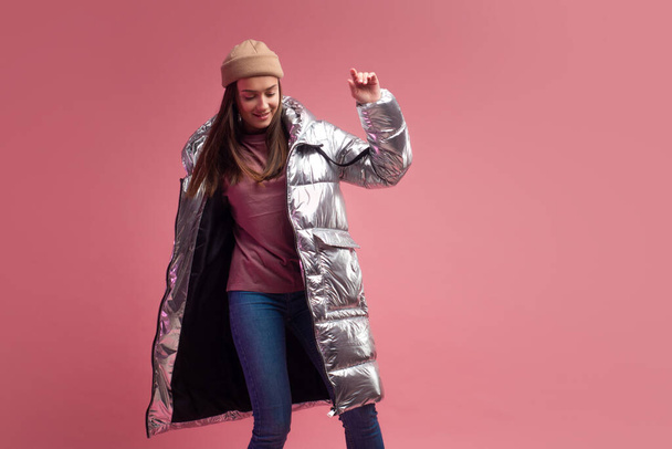 stylish and daring young girl in a silver down jacket - Φωτογραφία, εικόνα