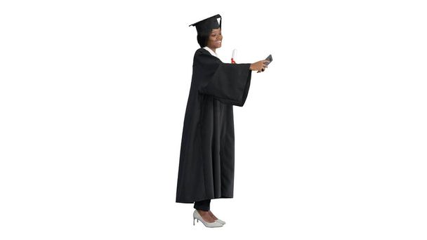 Happy African American female graduate holding diploma and makin - Zdjęcie, obraz