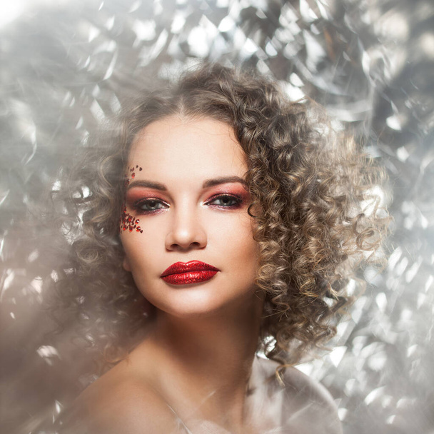 Young woman with shiny lips and gorgeous beautiful curly - Fotografie, Obrázek