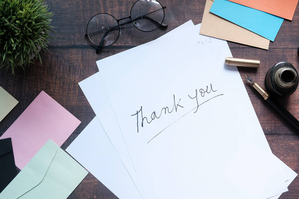 thank you message and envelope on wooden table  - Photo, image