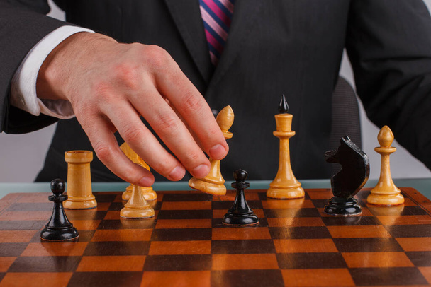Close up businessman hand playing chess game. - Photo, Image