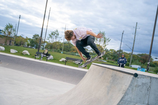 skaters are practicing tricks in an outdoor skate park in Detroit Michigan - 写真・画像