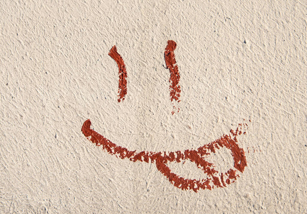 cement plaster wall background, pattern, smile, graffiti on the wall of a residential building - Foto, Imagem