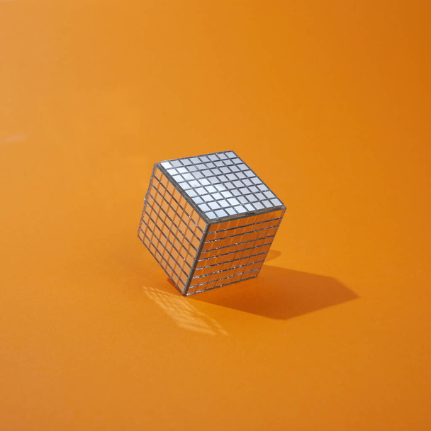 Disco ball cube on orange background. Minimal abstract concept - Foto, imagen