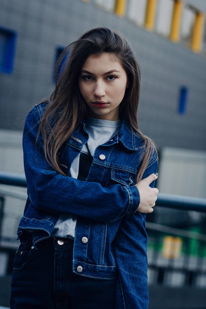 Portrait of beautiful girl. Pretty girl with long dark hair and red lips. Fashion portrait of young stylish hipster girl on street. - Foto, afbeelding