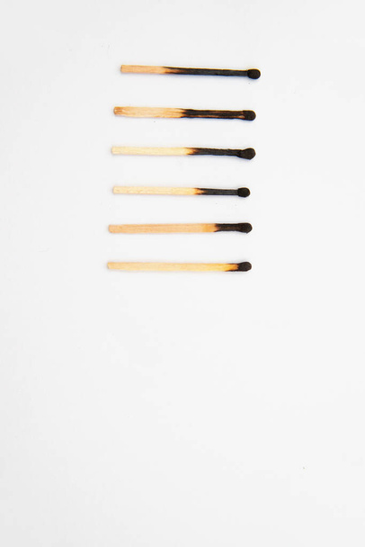 Different stages of burning matches. Matches stand in a row on a white background. - Photo, Image