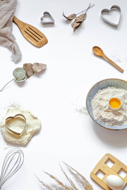 Composition with baking ingredients and kitchen accessories on a white background. - Foto, Bild