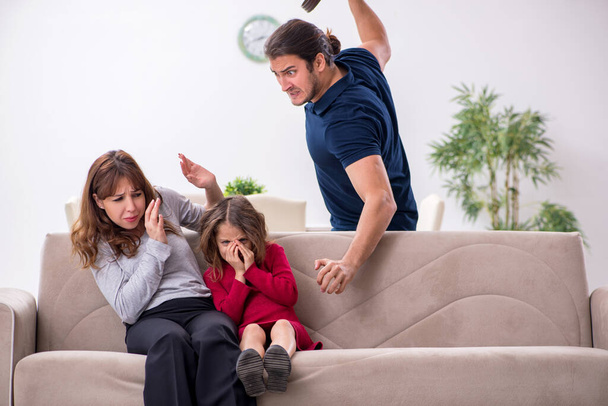 Young couple and their daughter in family conflict concept - Foto, imagen