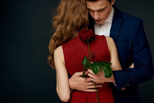 luxury couple hug romance relationship rose over dark isolated background - Photo, Image