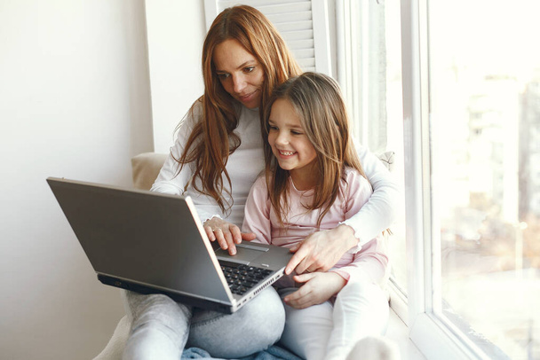 Woman with daughter using laptop computer - Φωτογραφία, εικόνα