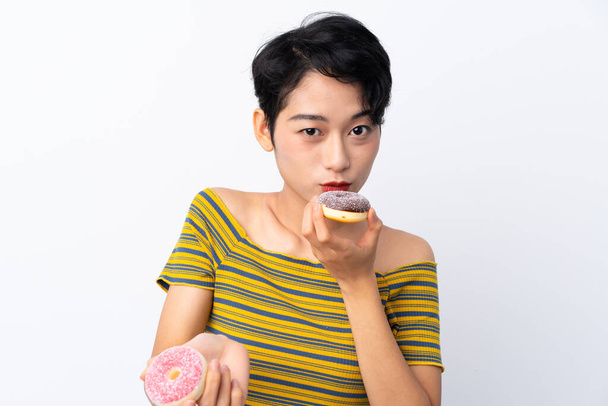 Joven asiática chica sosteniendo un donut - Foto, imagen
