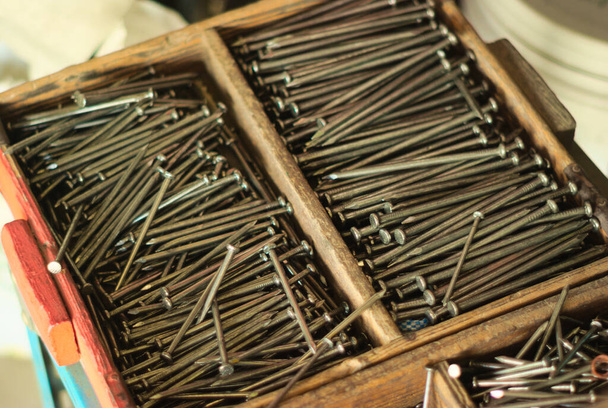 Steel nails in a wooden box at a construction supply store - Φωτογραφία, εικόνα
