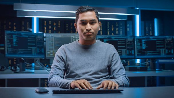Portrait of Software Programmer Sitting at His Desk and Working on Computer in Digital Identity Cyber Security Data Center. Hacking or Programming - Foto, afbeelding