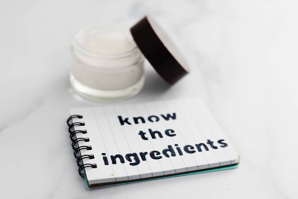 concept of organic and natural beauty products, moisturiser pot with memo saying Know the Ingredients - Photo, image