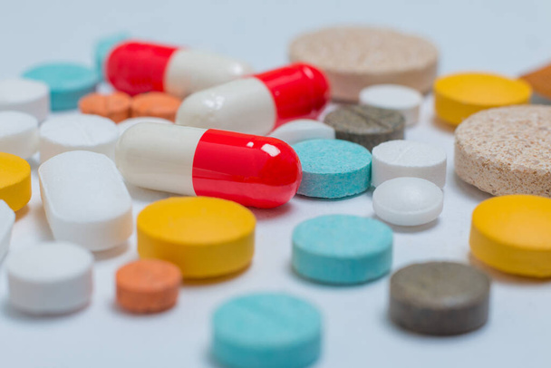 Extremo close-up em pílulas de cores diferentes em um fundo branco - Foto, Imagem
