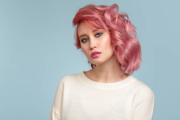 Портрет красивой женщины с розовыми волосами на синем фоне - Фото, изображение