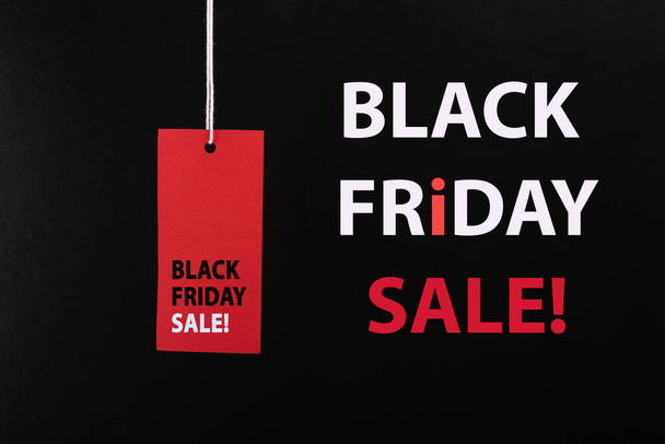 Black Friday sale concept. Red Sale tag color on the black background with Copy space. Black Friday weekend - Фото, зображення