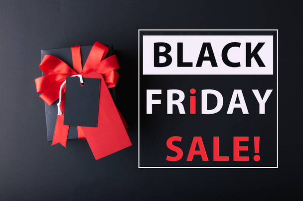 Black Friday sale concept. Red Sale tag  and Black Sale tag color on the black background with Copy space. Black Friday weekend - 写真・画像