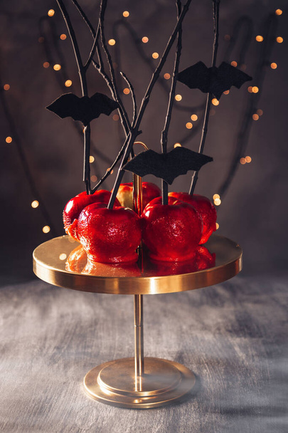  Red apples in caramel. Stylish sweets for Halloween. High quality photo - 写真・画像