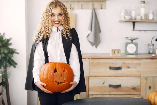 Woman in costume getting ready for halloween at home - Photo, image