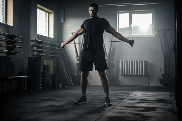 Sportive Man Stretch His Arms With Skipping Rope . - Photo, Image
