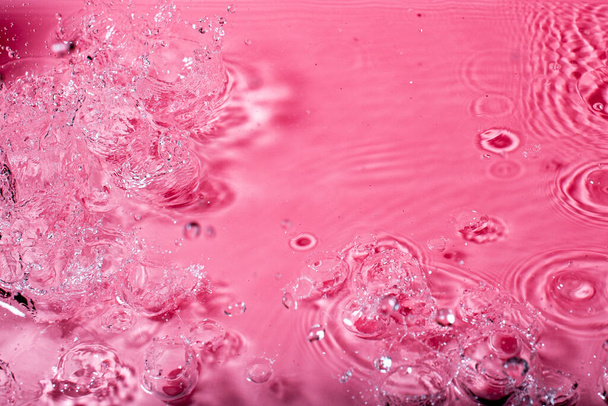splash of water on a red background. Abstract wallpaper - Foto, immagini