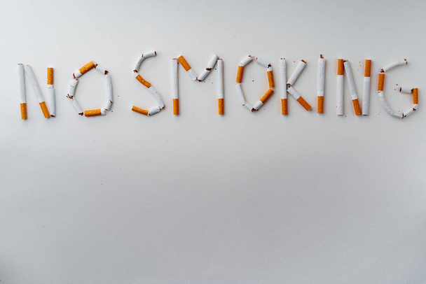 Inscription word NO SMOKING made out of cigarettes top view - Photo, image