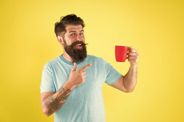 True specialty coffee is becoming big business. Energy concept. Hipster barista yellow background. Coffee shop. Bearded man drink morning coffee. Tea time. Cappuccino with right proportion of milk - Foto, Imagem