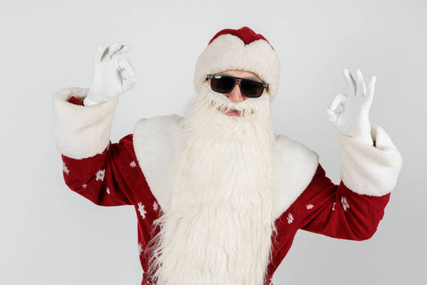 Christmas and New Years concept. Santa Claus shows OK gesture with both hands. Isolated background. - Фото, изображение