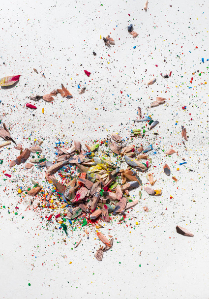 shavings from colored pencils on a white background, vertical format - Foto, Imagem