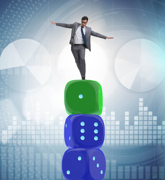 Businessman balancing on top of dice stack in uncertainty concep - Photo, Image