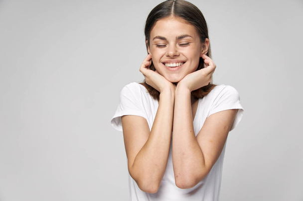 Cheerful woman smile closed eyes hands near face - Photo, image