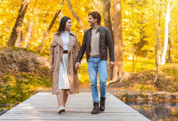Loving cheerful couple spending time at autumn forest - Photo, Image