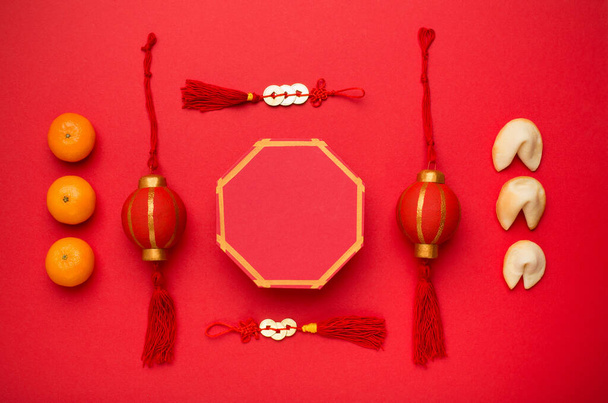 Flat lay fresh tangerines and fortune decoration on red - Fotografie, Obrázek