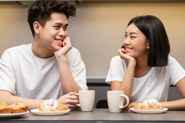 Korean Couple Drinking Morning Coffee And Eating Breakfast In Kitchen - Photo, Image