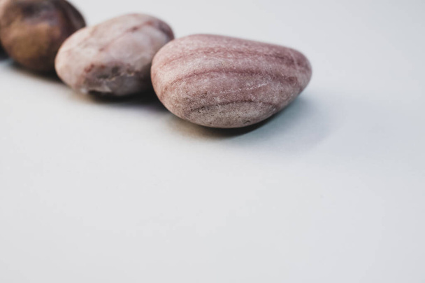 A closeup shot of pebbles isolated on a white background - Fotografie, Obrázek