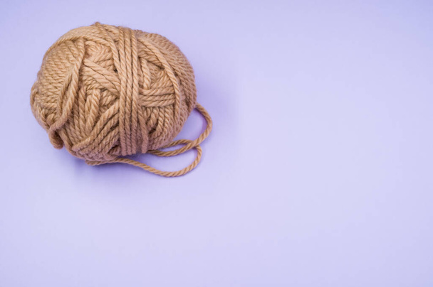 A high angle shot of a ball of yarn on a blue surface - Photo, image