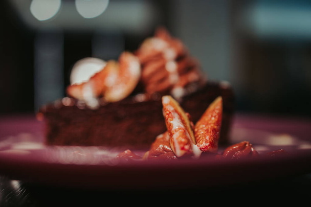 A closeup shot of a piece of chocolate cake with pecan and fig - Foto, Imagem