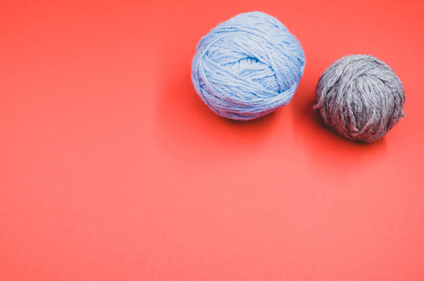Two wool and cotton yarns on an orange background - Φωτογραφία, εικόνα