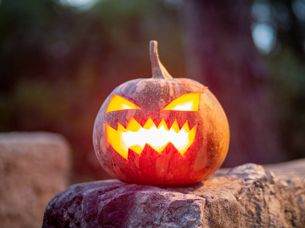 A closeup shot of a scary pumpkin lighten from the inside for a Halloween party - Zdjęcie, obraz